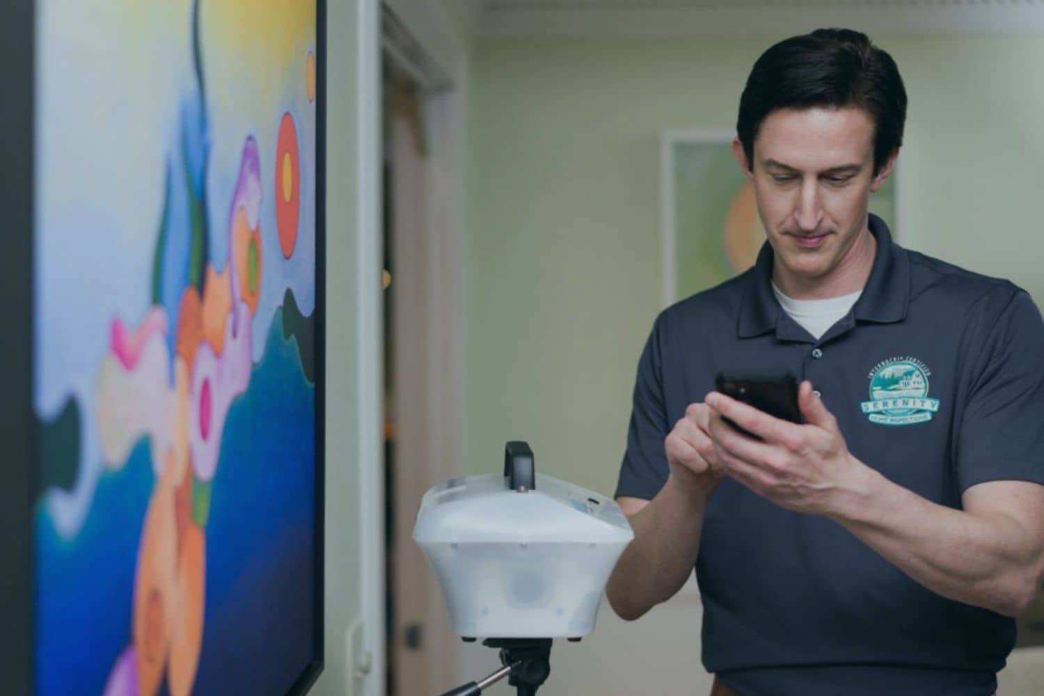 An InterNACHI certified home inspector from Serenity Home Inspections uses professional air sampling equipment and a smartphone to conduct a mold spore test, demonstrating a comprehensive inspection that answers the question 'do home inspectors check for mold?'.