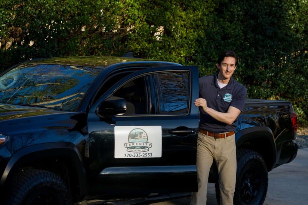 A Serenity Home Inspections inspector steps out of a branded company truck to provide home inspection services in Atlanta.
